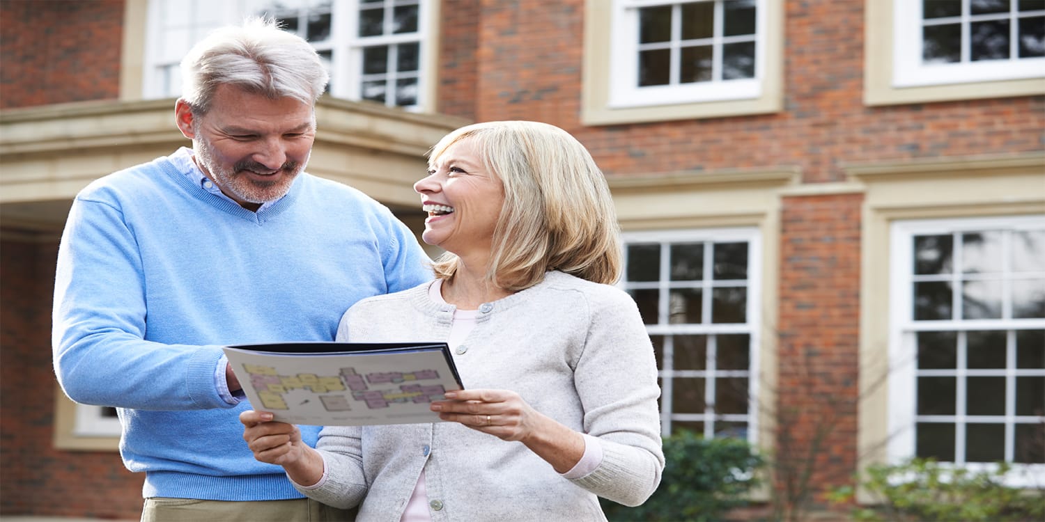 Home sellers looking at listing brochure - cash sale vs. traditional sale concept